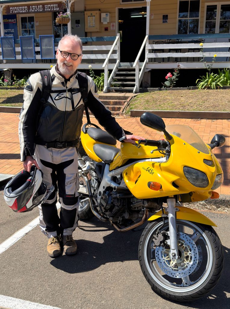 Don Hildred beside his motorbike